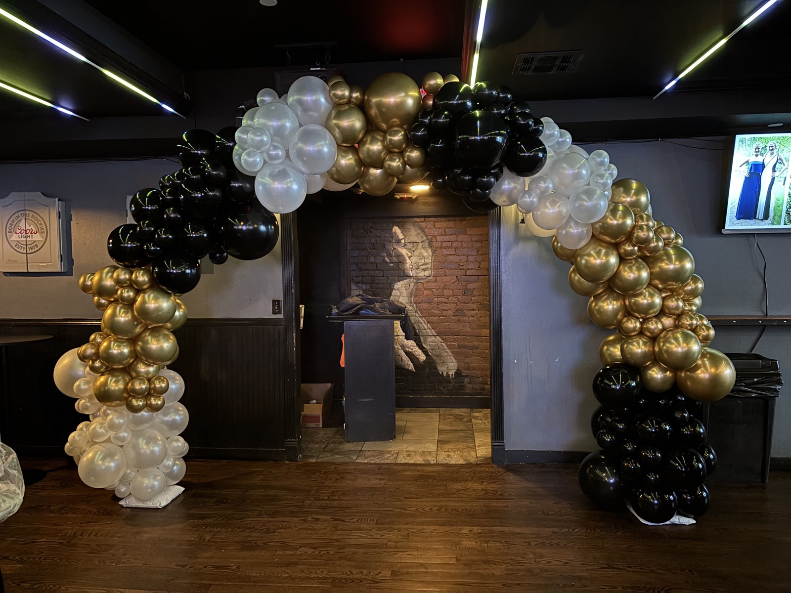 Black and chrome gold balloon arch for a luxury milestone soirée