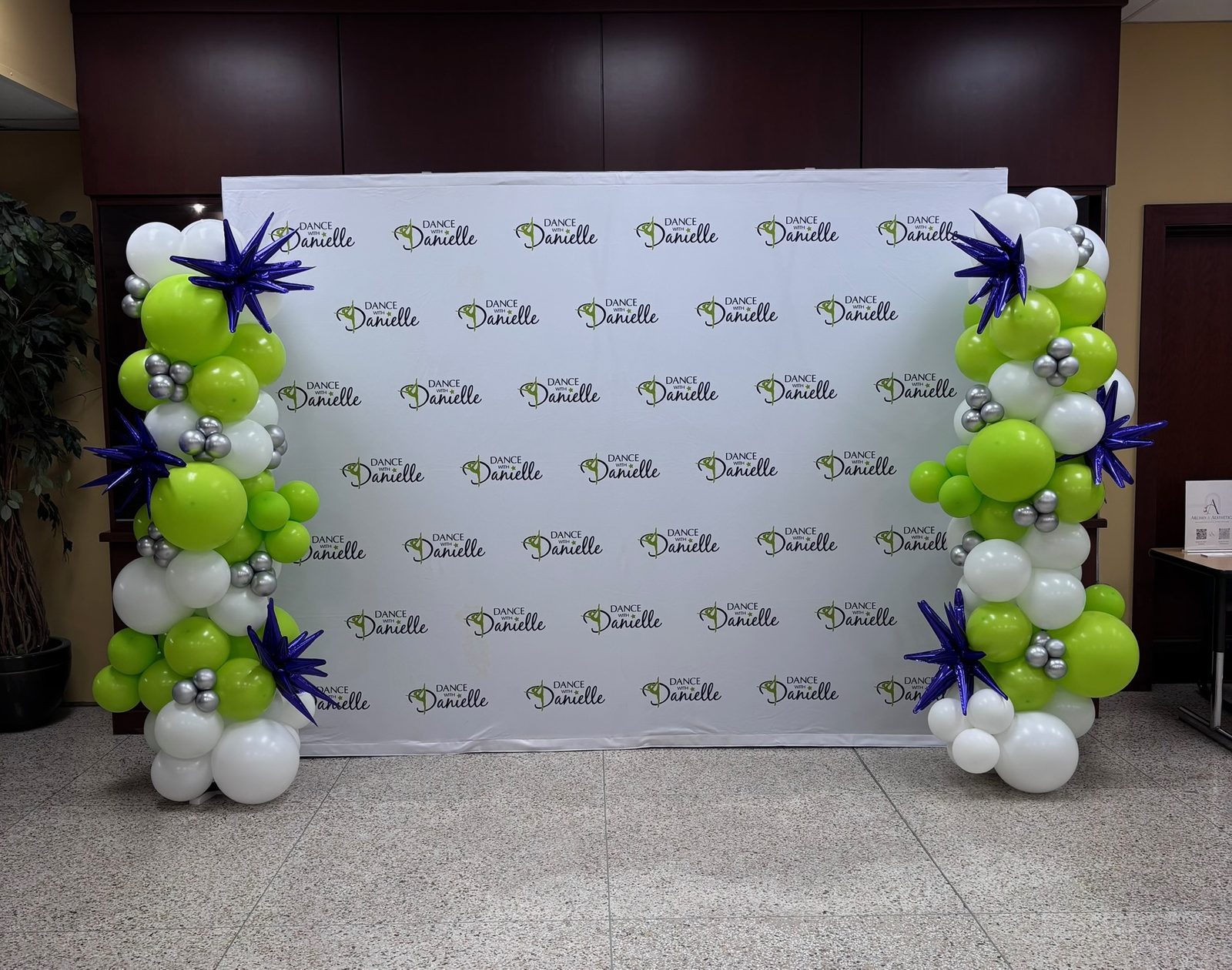 Corporate brand step-and-repeat balloon columns for a grand opening
