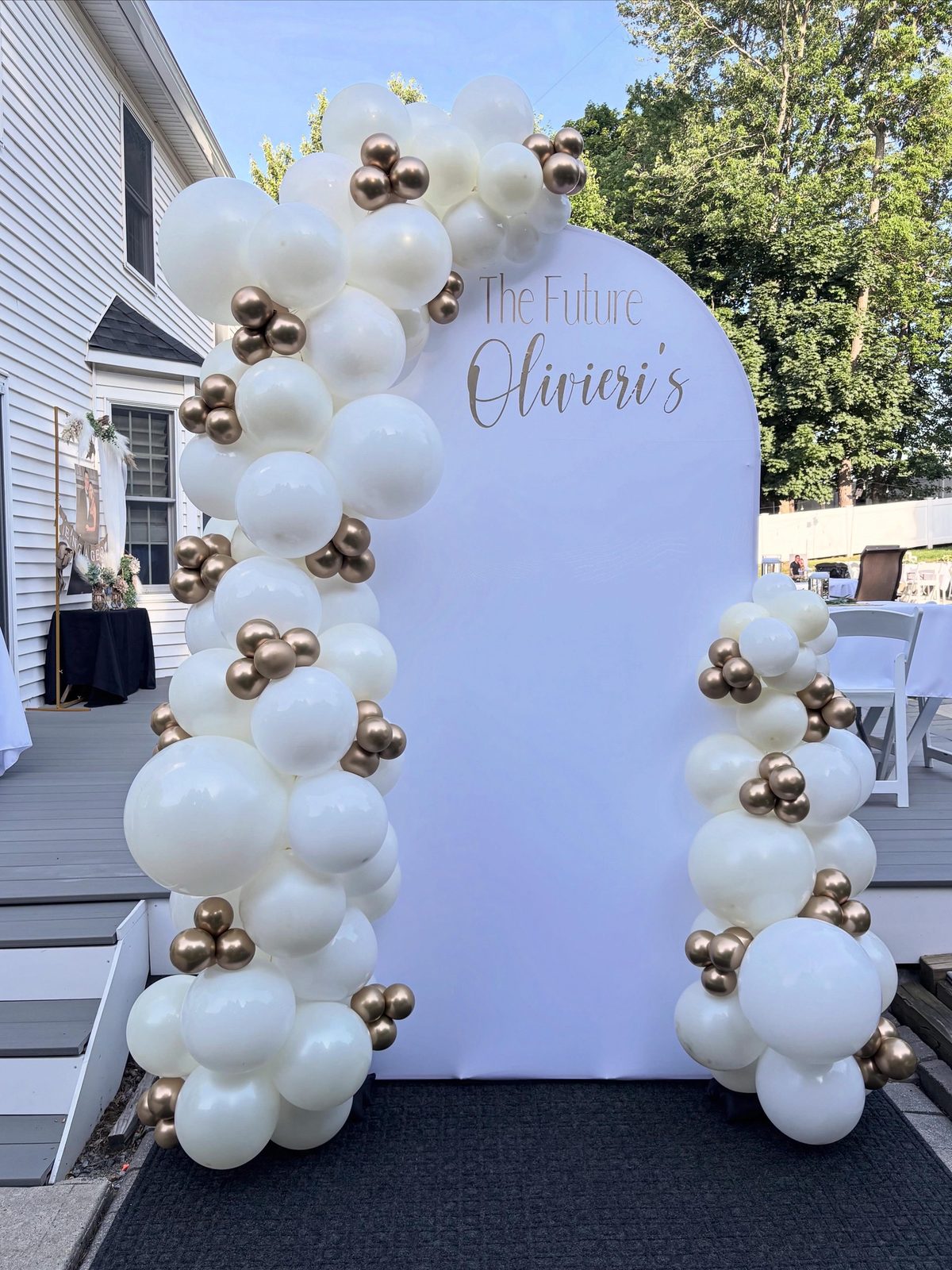 White and gold outdoor Chiara balloon arch for a luxury engagement by Arches & Aesthetics