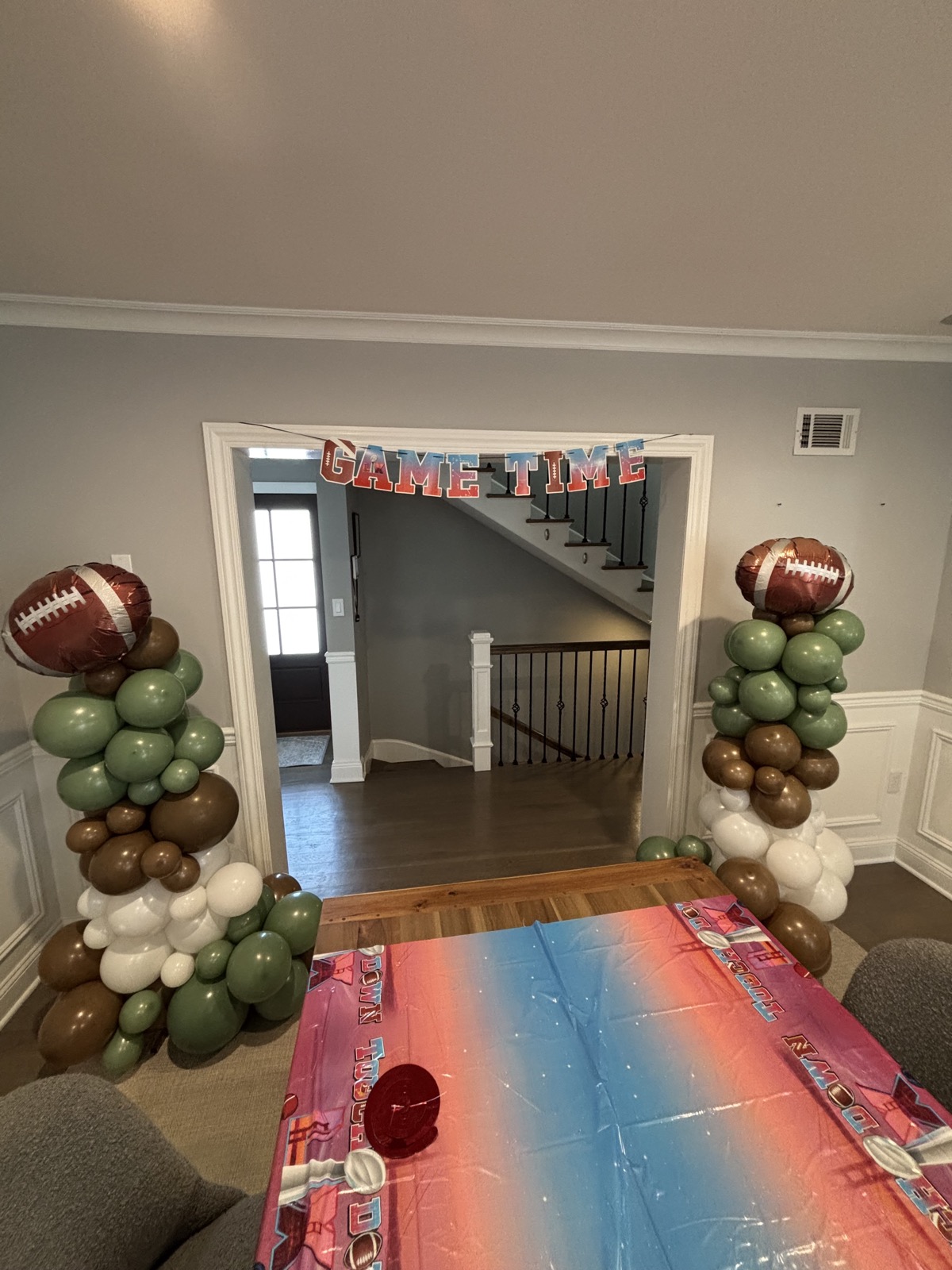 Game-day themed sage and brown balloon columns