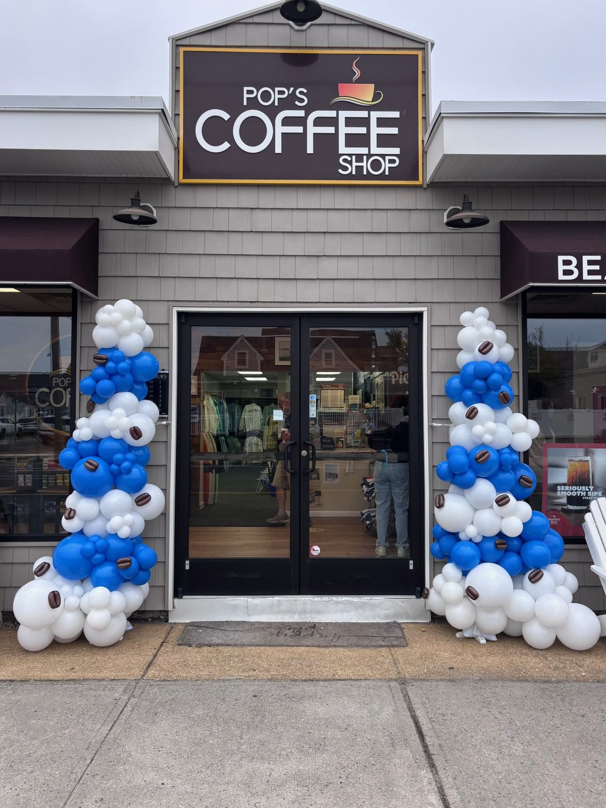 Grand opening organic balloon columns at a coffee shop storefront